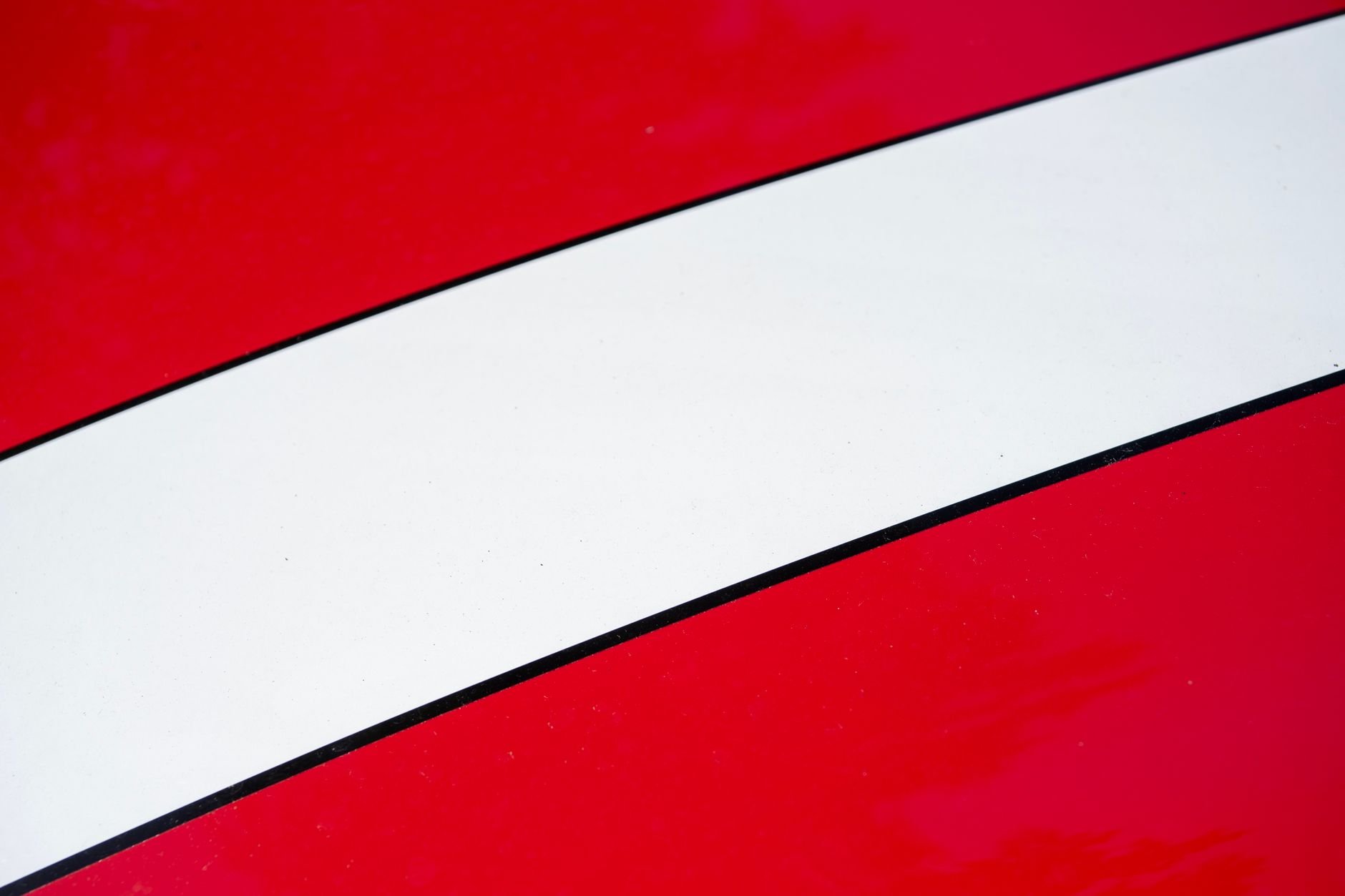 Close-up of a car body showing the precision of automotive surface protection.