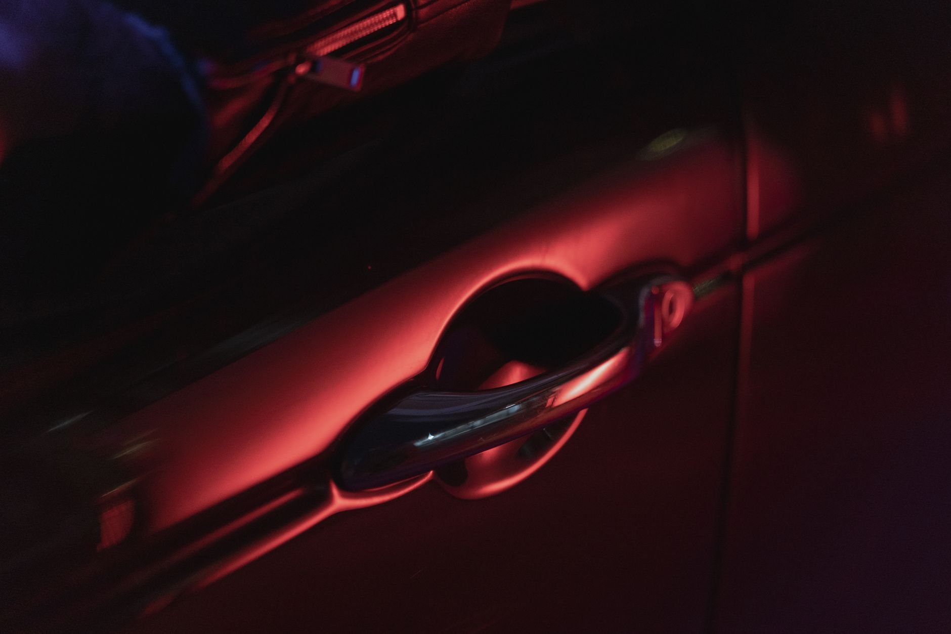Close-up of a car door handle illuminated in warm light — the kind of precision detail V2-C SOFT-ROLL guards.
